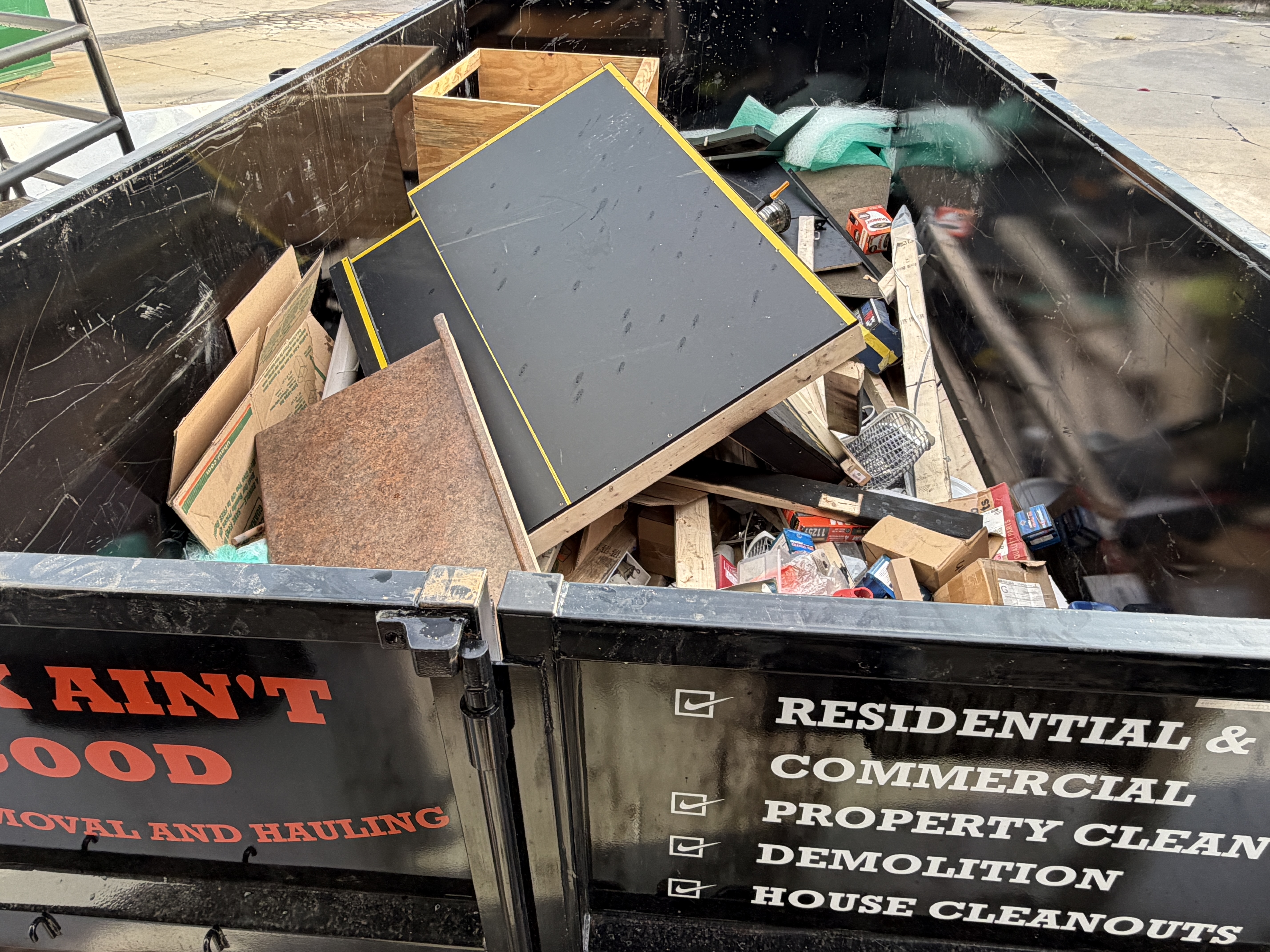 Junk Ain't Good trailer loaded with demolition debris