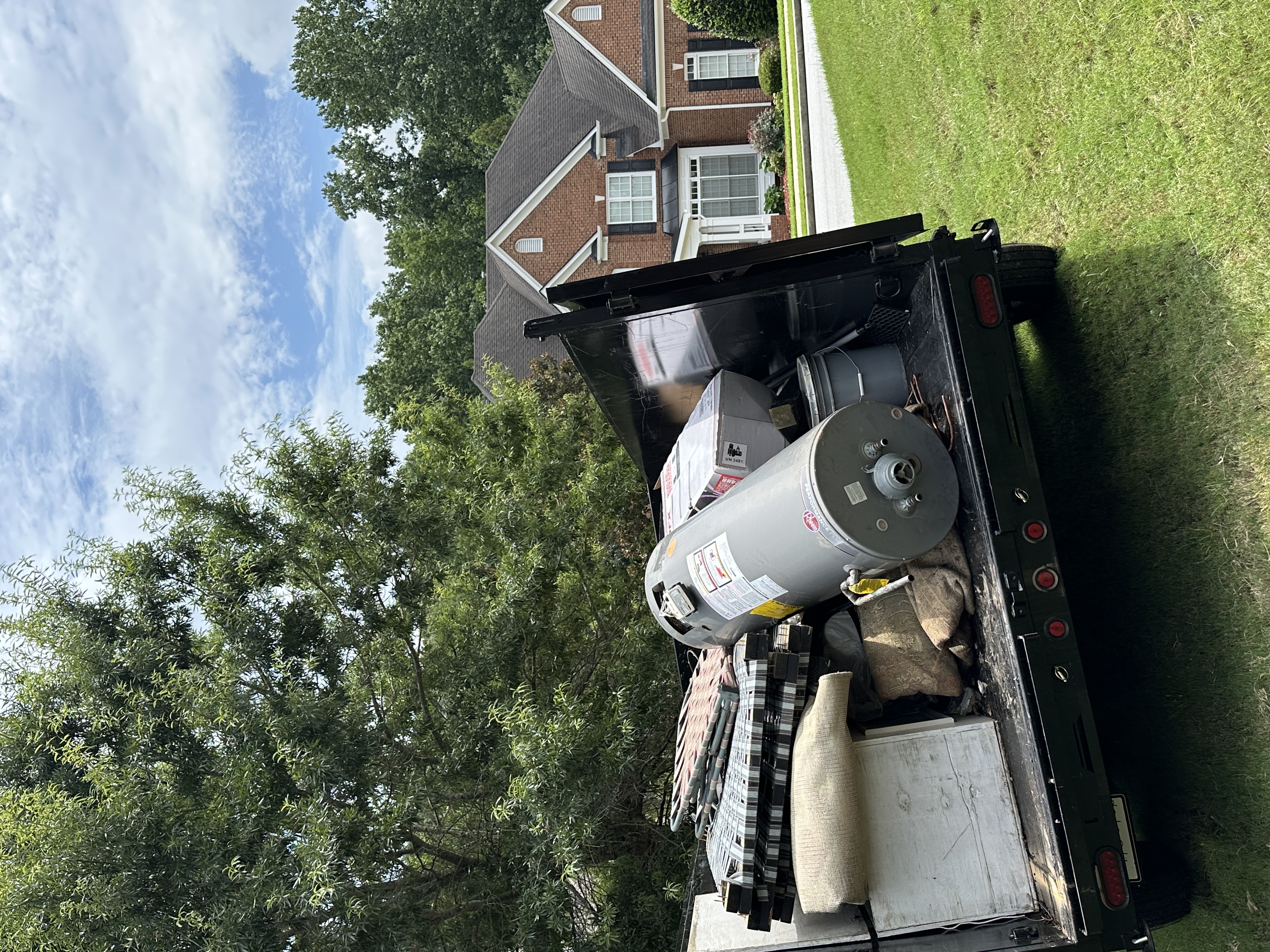Junk Ain't Good trailer loaded with household junk at a Gwinnett County home